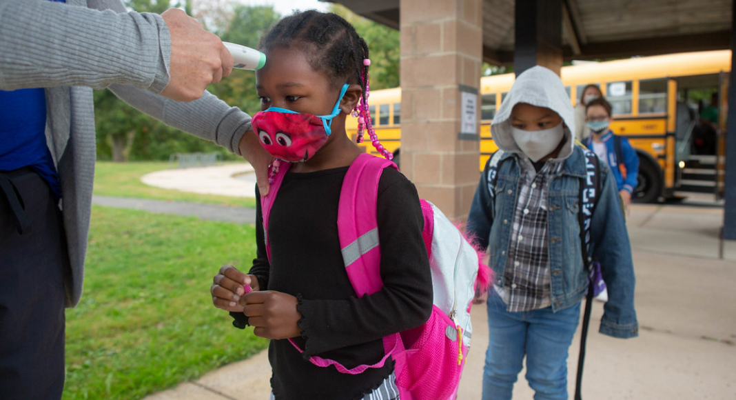 children in masks going to school