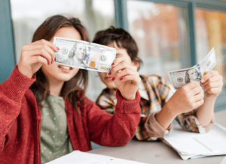 child's money personality; two children holding up paper money.