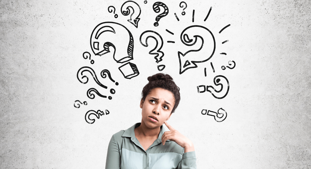 financial literacy: a woman is standing looking confused, with handdrawn question marks hovering around her head.