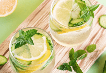 mocktails with lemon, cucumber, and mint on a wooden board.